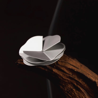 a special gift with your purchase — a free, eco-friendly paper incense holder crafted in a delicate silver petal shape